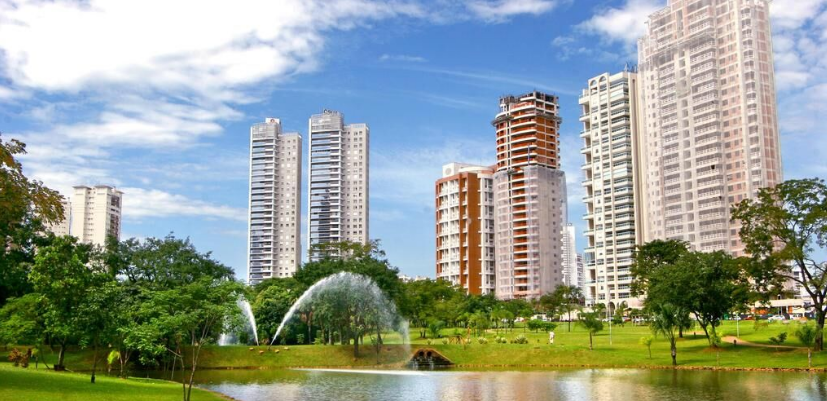 Vista de condomínios em Goiânia com áreas verdes, lago e chafariz